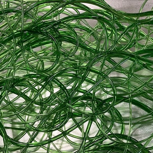 May include: A tangled mass of green glass tubing, creating a unique and abstract design.