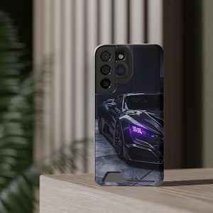 May include: A phone case featuring a dark purple sports car with bright purple headlights. The car is parked in a garage with a gray tiled floor. The phone case has a black camera module.