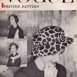 May include: Vintage Vogue printed pattern cover featuring a woman wearing a black and white spotted hat. The cover includes the text "VOGUE PRINTED PATTERN" and "22 HEAD SIZE". An original by John Frederics.
