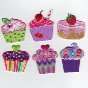 May include: Six colorful embroidered cupcake patches. Each patch features a different design, including cherries, strawberries, hearts, and sprinkles. The cupcakes are in various colors, such as pink, purple, green, and rainbow stripes. These patches are ideal for decorating clothing or accessories.