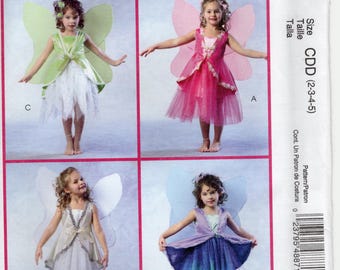 May include: A sewing pattern for four fairy costumes. The pattern includes instructions for making a green, pink, white, and blue fairy costume. The pattern is for sizes 2-3-4-5. The pattern is from McCall's Costumes.
