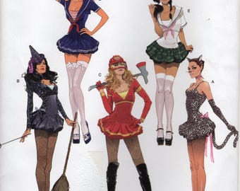 May include: Simplicity sewing pattern number 2072 for five different Halloween costumes. The costumes include a witch, a sailor, a firefighter, a school girl, and a cat. The pattern is for sizes H5 6, 8, 10, 12, and 14. EUR 32-40 FR 34-42.