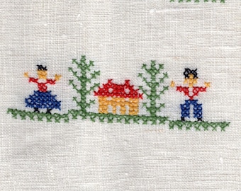 Vintage linen hand towel with folk cross stitch.