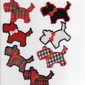 May include: Seven dog-shaped fabric patches in various colours and patterns, including tartan and houndstooth. Each dog has a bow tie. The patches are red, black, and white.