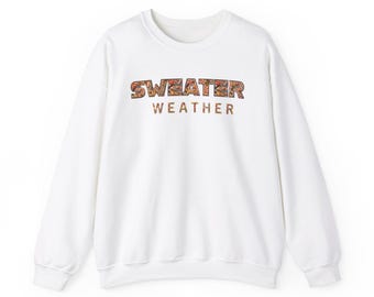 May include: White sweatshirt with a colorful "SWEATER WEATHER" graphic printed on the front.