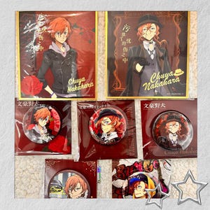 May include: A collection of Bungo Stray Dogs merchandise featuring Chuuya Nakahara. The items include square cards and round pinback buttons. The artwork depicts Chuuya in various poses, with text in Japanese and English.