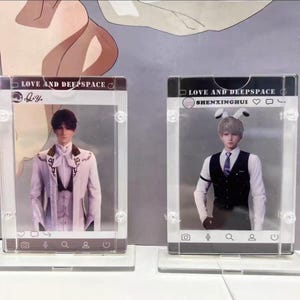 May include: Two clear acrylic photo frames with images of male figures. The frames have a social media interface design, with the text "LOVE AND DEEPSPACE" at the top. One figure wears a white suit, the other a vest and tie.