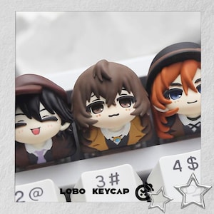 May include: Three custom keycaps featuring anime character designs. Each keycap has a unique character with detailed facial features and hair. The keycaps are on a white keyboard with the text "LOBO KEYCAP" visible.