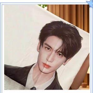May include: A rectangular white pillowcase featuring a high-resolution printed portrait of a person with dark hair, wearing a white collared shirt under a black blazer. The image captures the head and shoulders of the individual against a plain background.