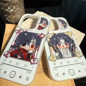 May include: Two white phone cases with anime-style character illustrations. Each case features a different character in a red and black outfit. The cases have a music player interface design with play, pause, and skip buttons, and the text "SO COOL".