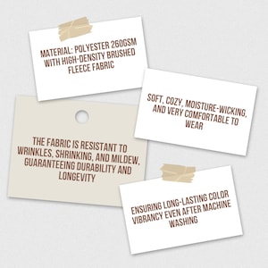May include: Image features four tan sticky notes with text describing fabric properties. The notes state the material is polyester 260GSM, high-density brushed fleece, resistant to wrinkles, shrinking, and mildew, and ensures long-lasting color vibrancy.