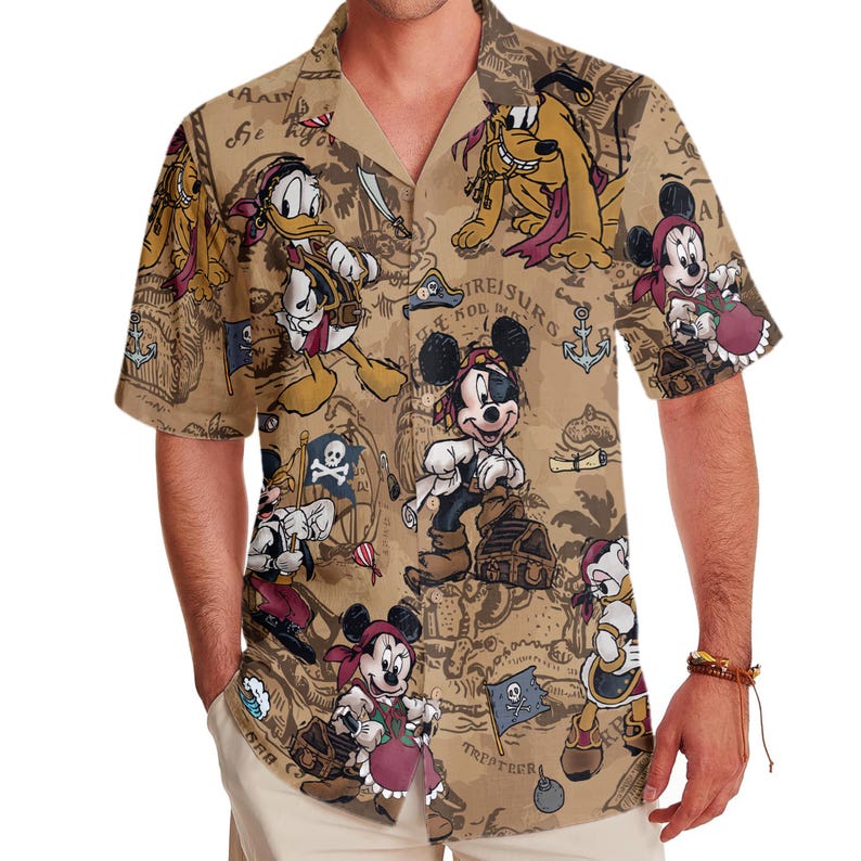 May include: A brown short-sleeved button-down shirt with a tropical print featuring Mickey Mouse, Donald Duck, and Goofy characters. The print includes a treasure map design with the text "TREASURS" and "TRITATERA".