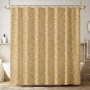 May include: A shower curtain with a beige background and a gold floral pattern.