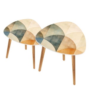 May include: Two small, triangular side tables with a watercolor-style geometric pattern in shades of beige, blue, and orange. The tables have light-colored wooden legs and a white trim around the tabletop.