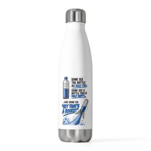 May include: A white stainless steel water bottle with a silver cap. The graphic features a water bottle illustration with the text: Some see the bottle as half full, some see a bottle that is half empty... and some go: Hey that's a rocket.