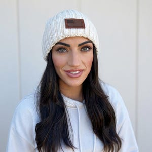 Warm Winter USA Patriotic American Flag 1776 Beanie One size fits all cream color with leather patch. perfect gift for holidays & Christmas