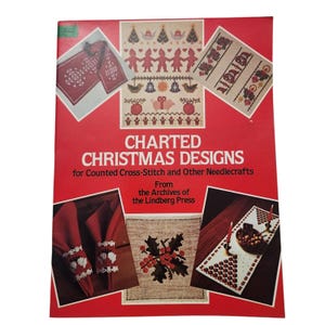 May include: A red book cover with the title "CHARTED CHRISTMAS DESIGNS" and various cross-stitch patterns. The book features images of Christmas-themed needlecraft projects, including ornaments and table settings. The text "for Counted Cross-Stitch and Other Needlecrafts" is also visible.