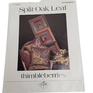 May include: A white paper with the title "Split Oak Leaf" and the brand "thimbleberries" is displayed. The image shows a quilt and pillows with a split oak leaf design. The quilt and pillows are in shades of red, brown, and green.