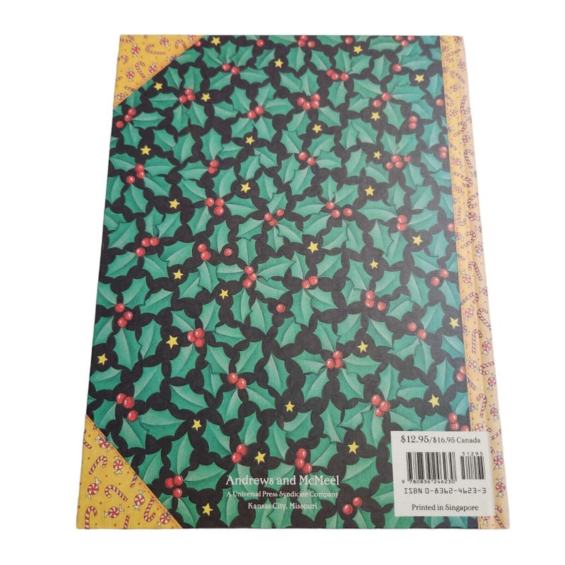 May include: The back cover of a book with a holly pattern. The book is titled "Andrews and McMeel" and is a Universal Press Syndicate Company. The book is printed in Singapore.