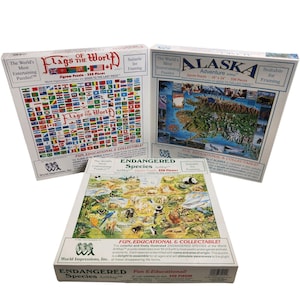 Könnte beinhalten: Drei Puzzleboxen mit bunten Bildern von Flaggen aus aller Welt, einer Karte von Alaska und gefährdeten Tieren. Jede Box trägt den Text "Fun, Educational & Collectible!" und das World Impressions Logo.