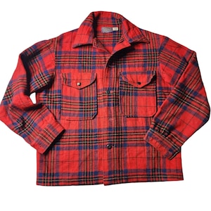 May include: Red and black plaid flannel shirt with a button-up front and two flap pockets.