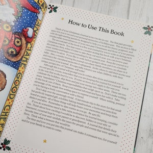 May include: A book titled "How to Use This Book" with a red and white star design on the cover. The book is open to a page with instructions on how to use a Christmas journal.