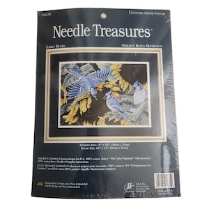 May include: Needle Treasures counted cross stitch kit, Early Blues, featuring three blue jays perched on sunflowers. The finished size is 14 inches by 10 inches, and the frame size is 18 inches by 14 inches.