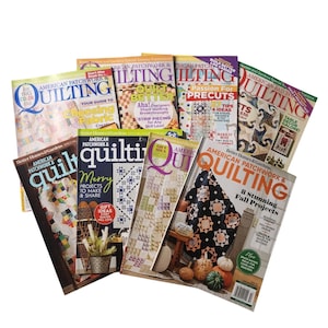 May include: A collection of American Patchwork & Quilting magazines featuring various cover designs, colorful quilt patterns, and text including titles like Quilt Better, Passion for Precuts, and 8 Stunning Fall Projects, arranged in a layered stack.