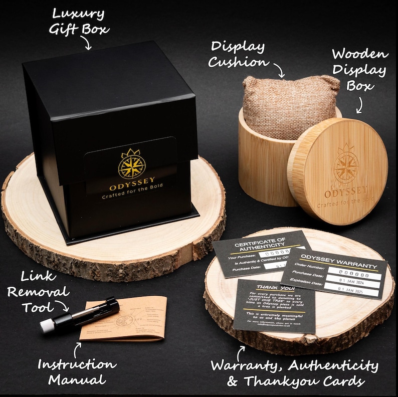 An Image of the watches packing, including a black luxury gift box, wooden display box and cushion, metal link removal tool, and warranty, authenticity and thank you cards.