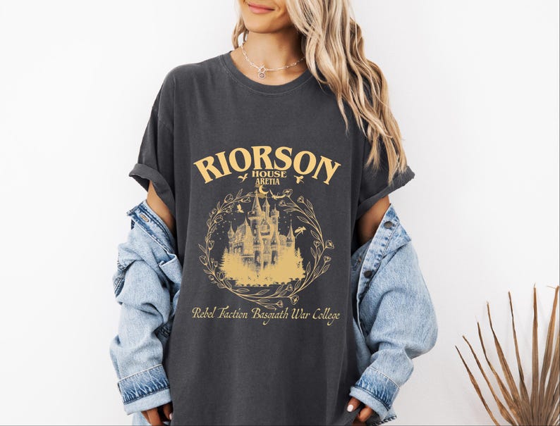 a woman wearing a black shirt with a castle on it