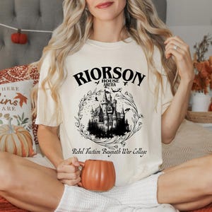 a woman sitting on a bed holding a mug