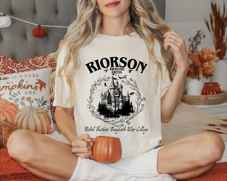 a woman sitting on a bed holding a mug