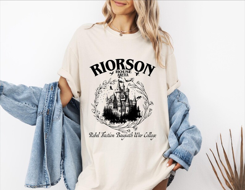 a woman wearing a white shirt with a castle on it