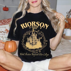 a woman sitting on a bed holding a pumpkin