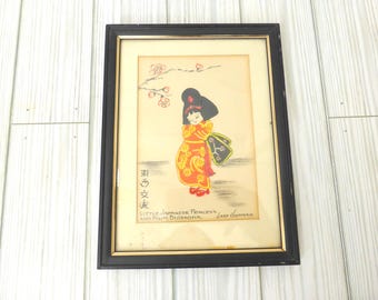 May include: A framed illustration of a figure in a red and yellow patterned kimono with black hair, standing beneath a branch of pink plum blossoms. The text reads "Little Japanese Princess and Plum Blossoms" and "Ladd Hoffman" with Japanese characters.