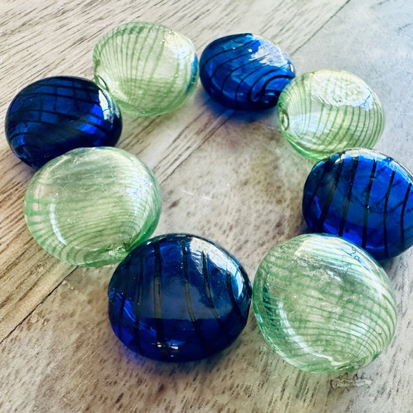 Eight Large and Luminous Hand Blown Glass Hollow Disc Beads