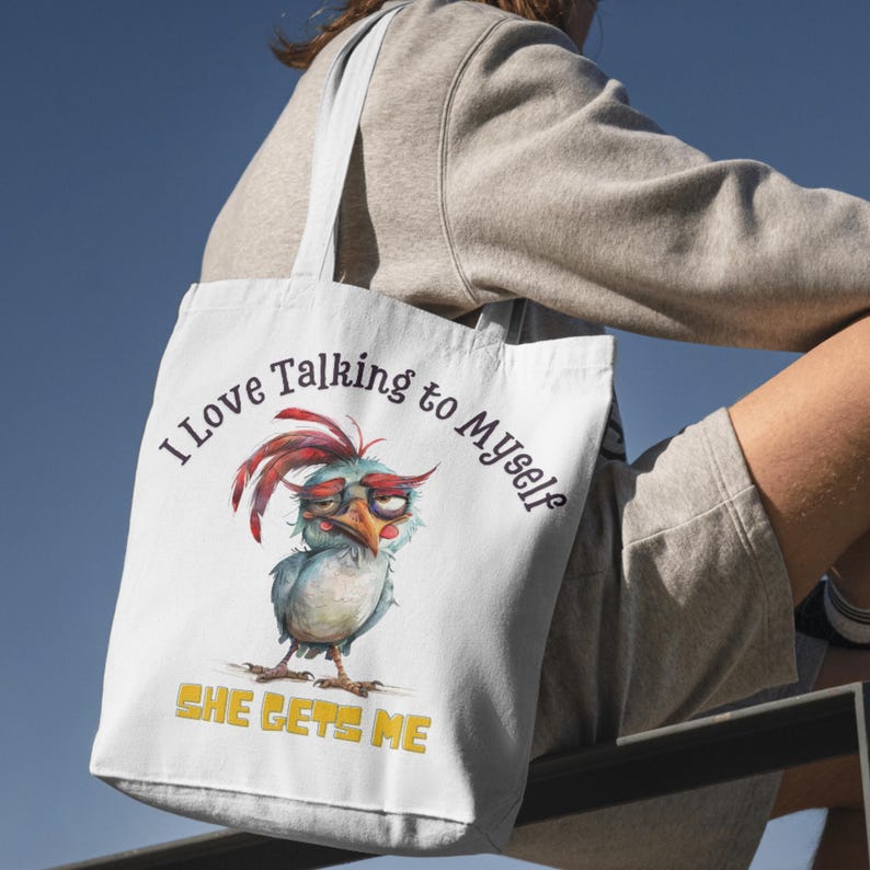 May include: White tote bag with a cartoon bird illustration and the text "I love talking to myself. She gets me."