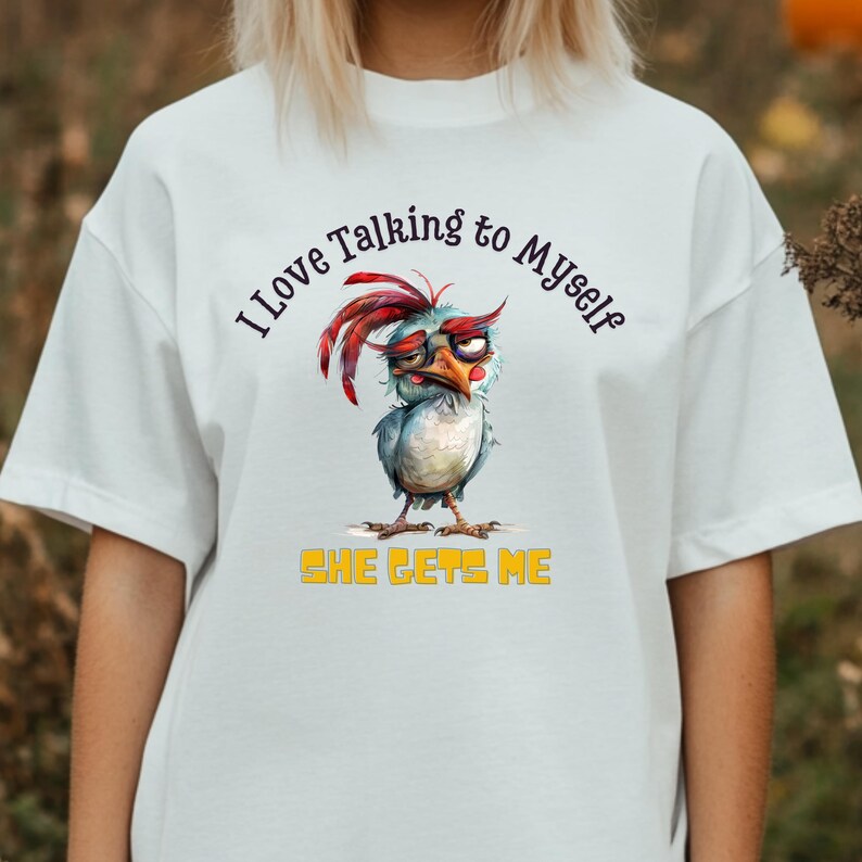 May include: White t-shirt with a cartoon chicken wearing glasses and the text "I love talking to myself. She gets me."