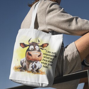 May include: A white tote bag with a cartoon cow illustration and the text "I am not responsible what my face does when you talk!"
