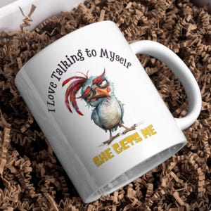 May include: White ceramic coffee mug with a cartoon chicken illustration and the text "I love talking to myself she gets me".