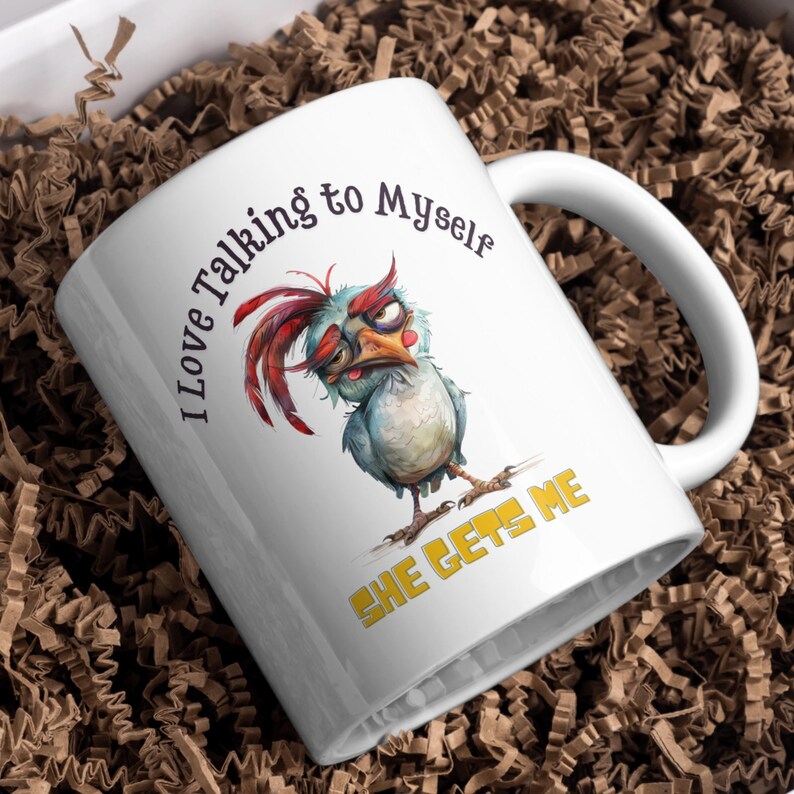 May include: White ceramic coffee mug with a cartoon chicken illustration and the text "I love talking to myself she gets me".