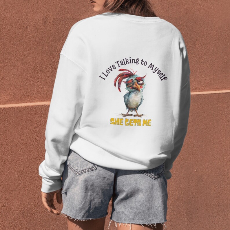 May include: White sweatshirt with a cartoon chicken wearing glasses and the text "I love talking to myself, she gets me".