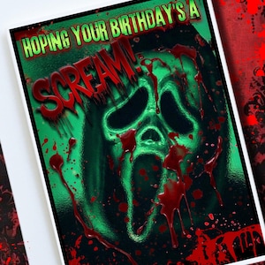 May include: A birthday greeting card with a Scream mask design. The card features a green and black background with the text "Hoping Your Birthday's A Scream!" in green and red, with blood splatter details.