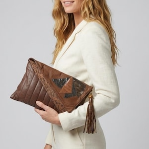 May include: A white ceramic mug with a black handle and the text "But first, coffee" in a handwritten style. The mug is on a white surface. The mug is approximately 4 inches tall.