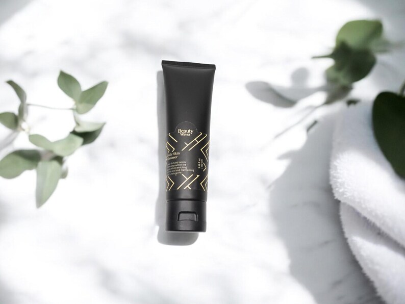 Beauty Wavez Daily Skin Cleanser on sunlit marble counter, surrounded by soft eucalyptus leaves and spa towels for a clean, minimal skincare aesthetic.