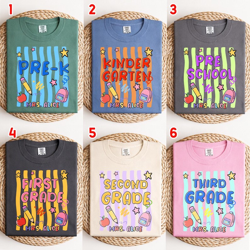 May include: Six crew neck t-shirts in green, blue, dark gray, charcoal, cream, and pink. Each features a graphic with vertical stripes, a pencil, an apple, a backpack, stars, and text including grade levels and the name Mrs. Alice.