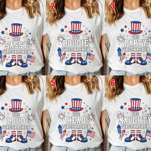 May include: A white t-shirt featuring a graphic of a red, white, and blue top hat, fireworks, a rocket, a small American flag, and a pair of shoes with striped socks. The text reads THE SASSY, BOUGIE, PARTY, LOUD, HEAD, or NAUGHTY FIRECRACKER.