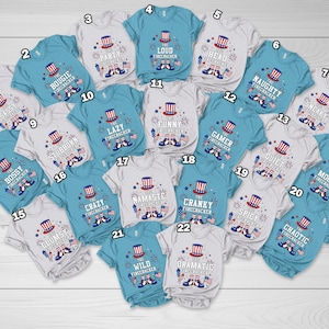 May include: A collection of twenty-two short-sleeved t-shirts in white and light blue, each featuring a graphic of a patriotic top hat, fireworks, and American flags, with unique text labels like The Bougie Firecracker and The Loud Firecracker.