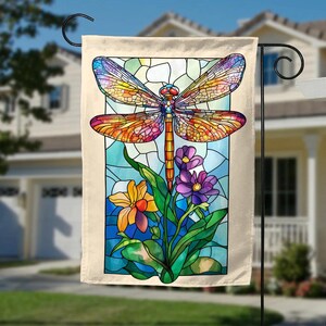 May include: A stained glass style garden flag featuring a colorful dragonfly with red, orange, yellow, green, and blue accents. The dragonfly is perched on a stem with purple and yellow flowers.