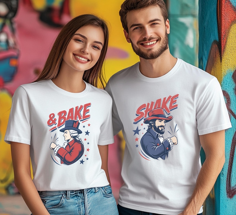 May include: Two white short-sleeved t-shirts featuring graphic prints. The left shirt displays a historical figure in a red coat with the text & BAKE. The right shirt shows a bearded figure in a blue coat with the text SHAKE, both with stars.